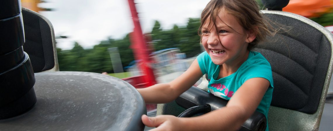 Young female guest riding Tornado at Tweetsie Railroad