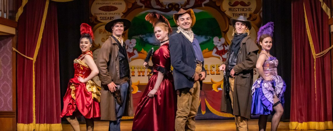 Can-Can Dancers and cowboys pose together on stage at the Tweetsie Palace at Tweetsie Railroad.