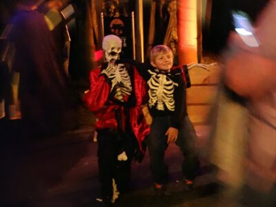 A child sitting with a skeleton prop during Ghost Train Halloween Festival at Tweetsie Railroad, Blowing Rock, North Carolina