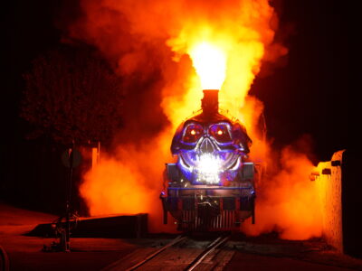 The Ghost Train with smoke and fire billowing out upon its entrance to Main Street at Tweetsie Railroad during the annual Ghost Train Halloween Celebration.