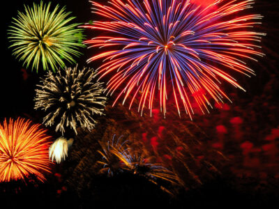 Brilliant green, orange, purple, and white fireworks